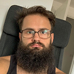 Man with a beard and glasses sitting on a black chair